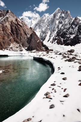 Lago glaciale sul ghiacciaio Godwin Austen, sullo sfondo la cresta ovest del Gasherbrum IV (7925m) in Karakorum, Pakistan.